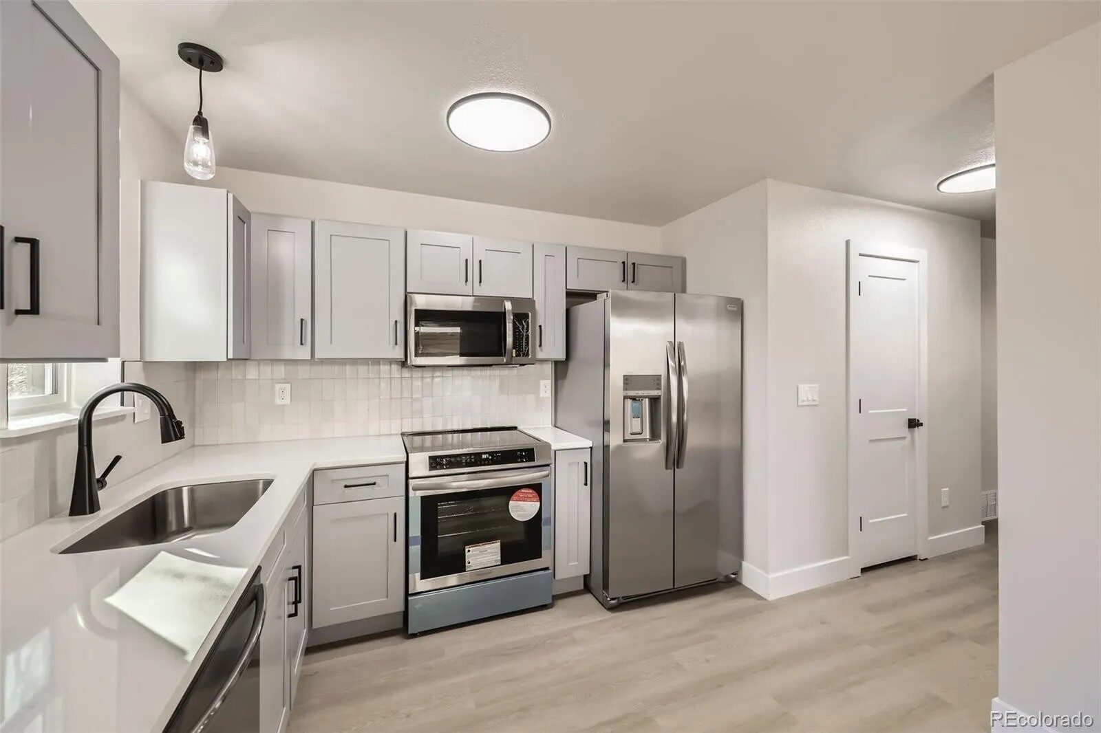 Custom kitchen cabinetry and quartz countertop detail in Northern Colorado by Blue Springs Construction