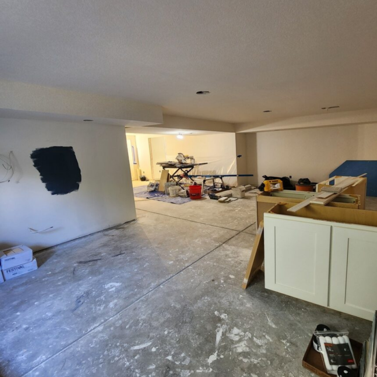 Basement under construction with cabinetry being installed