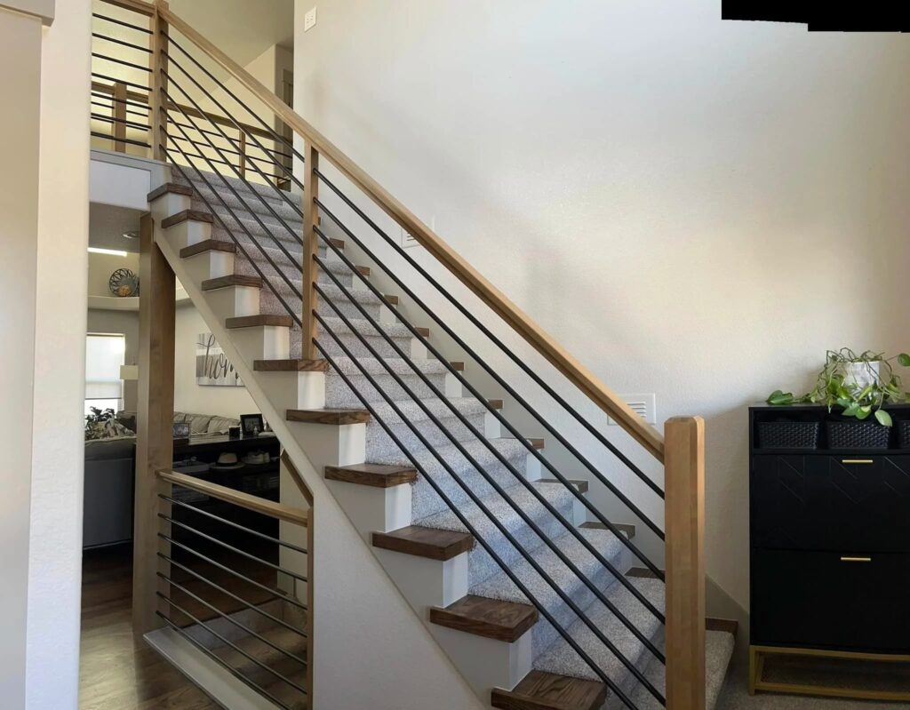 Opened-up stair with custom horizontal steel rail in a Windsor whole-home remodel